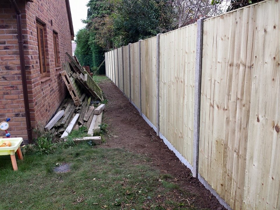 Closeboard fencing along a garden boundary