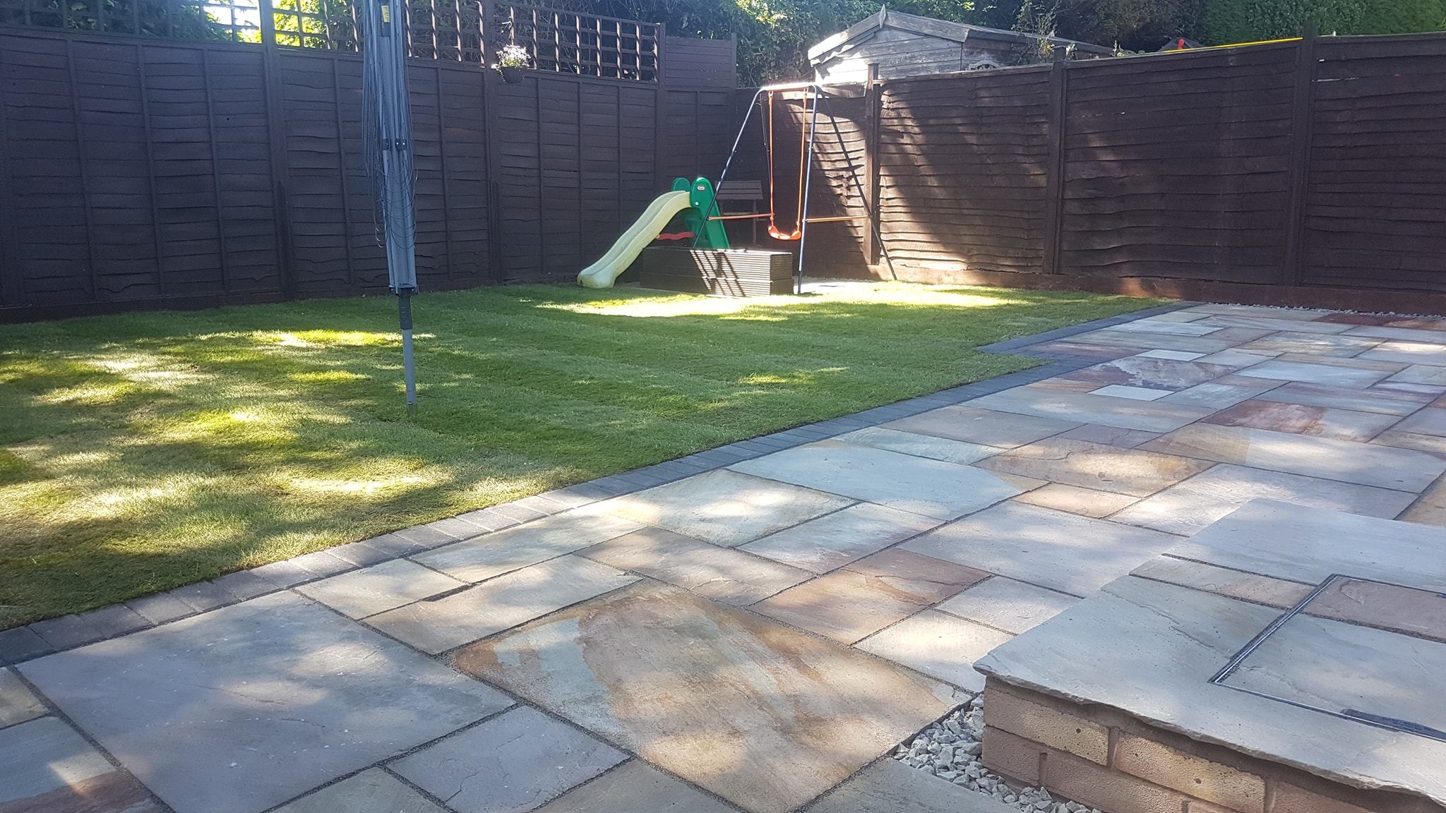 Sandstone paving and turf laid by Hereford Fencing & Landscaping