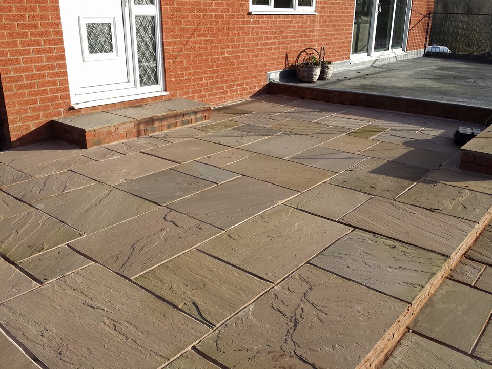 Sandstone patio with lawn