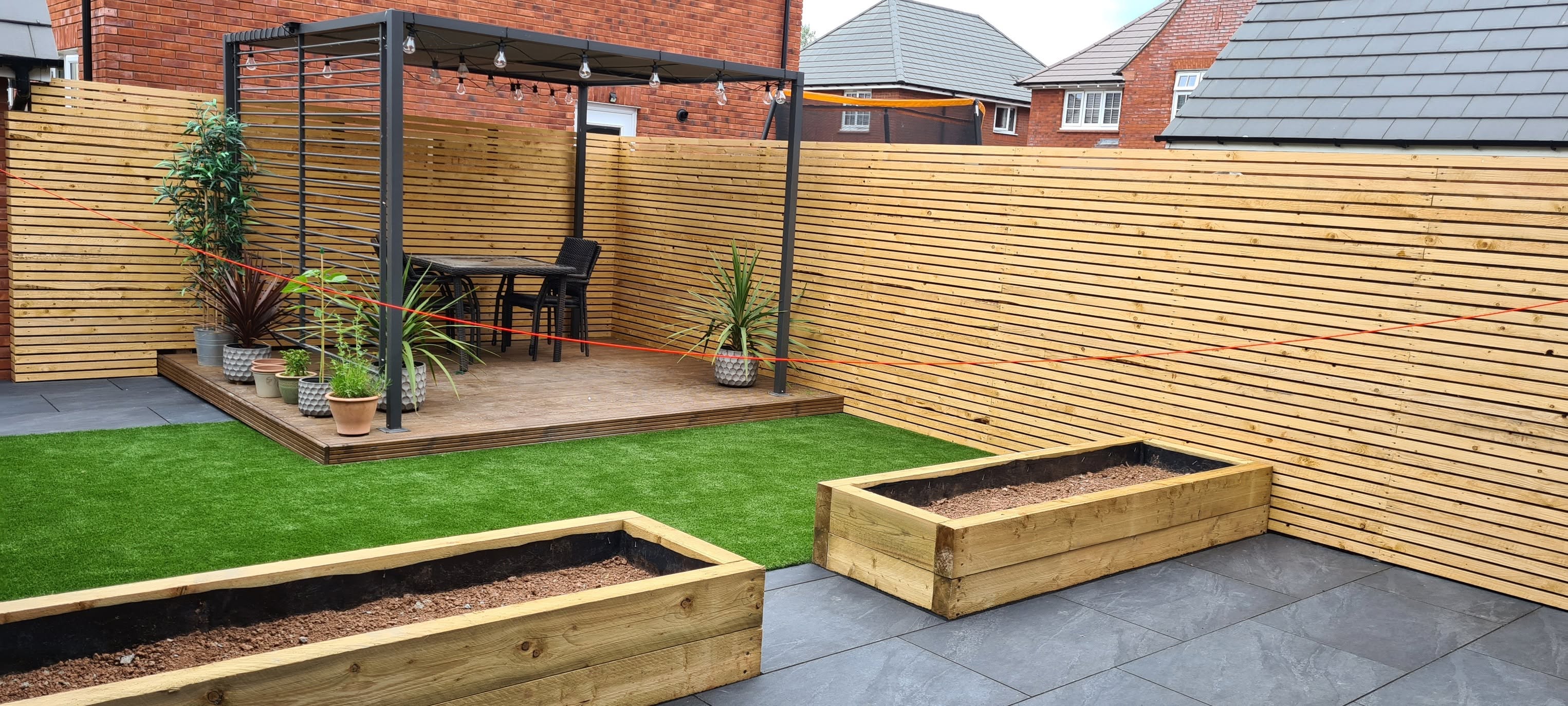 Composite decking with pergola and raised beds